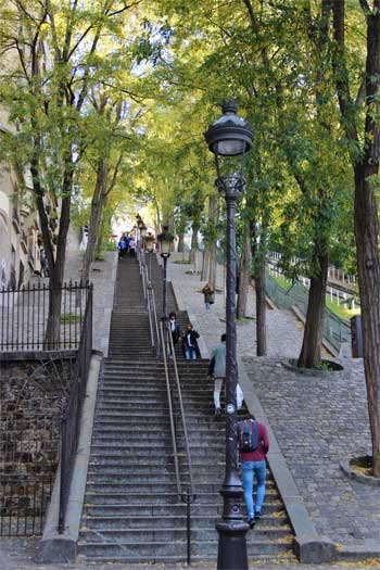 Marches raides menant à Montmartre, bordées d'arbres et de lampadaires